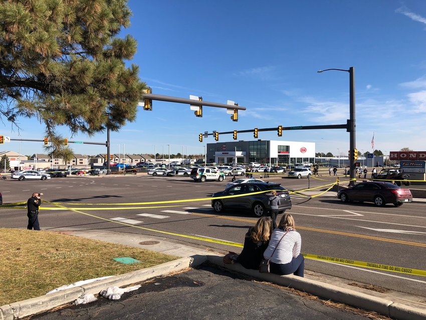 Authorities investigate the scene of a shooting near the intersection of Arapahoe Road and Dayton Street the morning of Nov. 15.